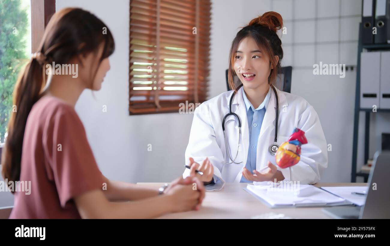 Fema Doctor Asian cardiologist doctor women explaining about anatomical of human ...