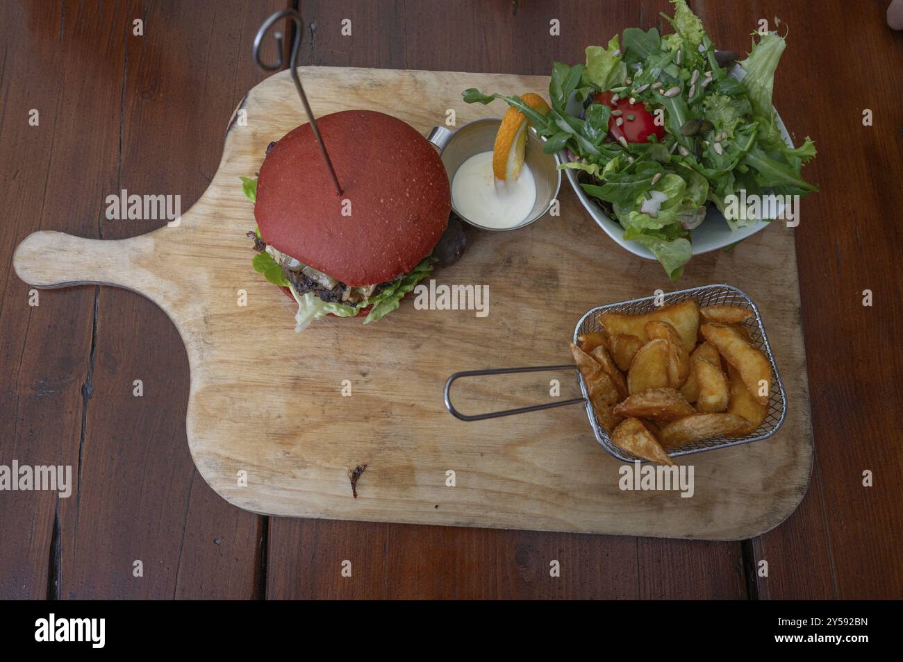 Veggie burger with fries and salad served on a wooden board, Bavaria, Germany, Europe Stock Photo