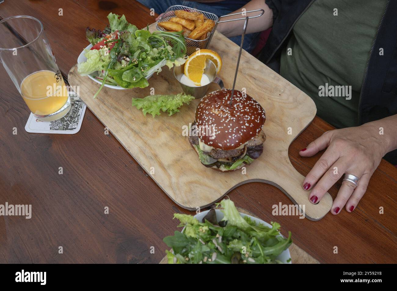 Veggie burger with fries and salad served on a wooden board, Bavaria, Germany, Europe Stock Photo