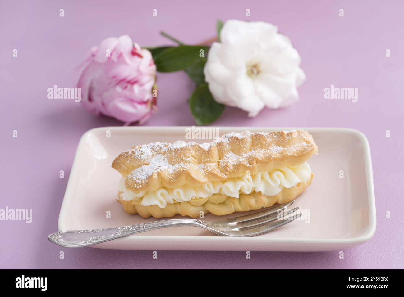 Eclairs with buttercream filling and powdered sugar Stock Photo