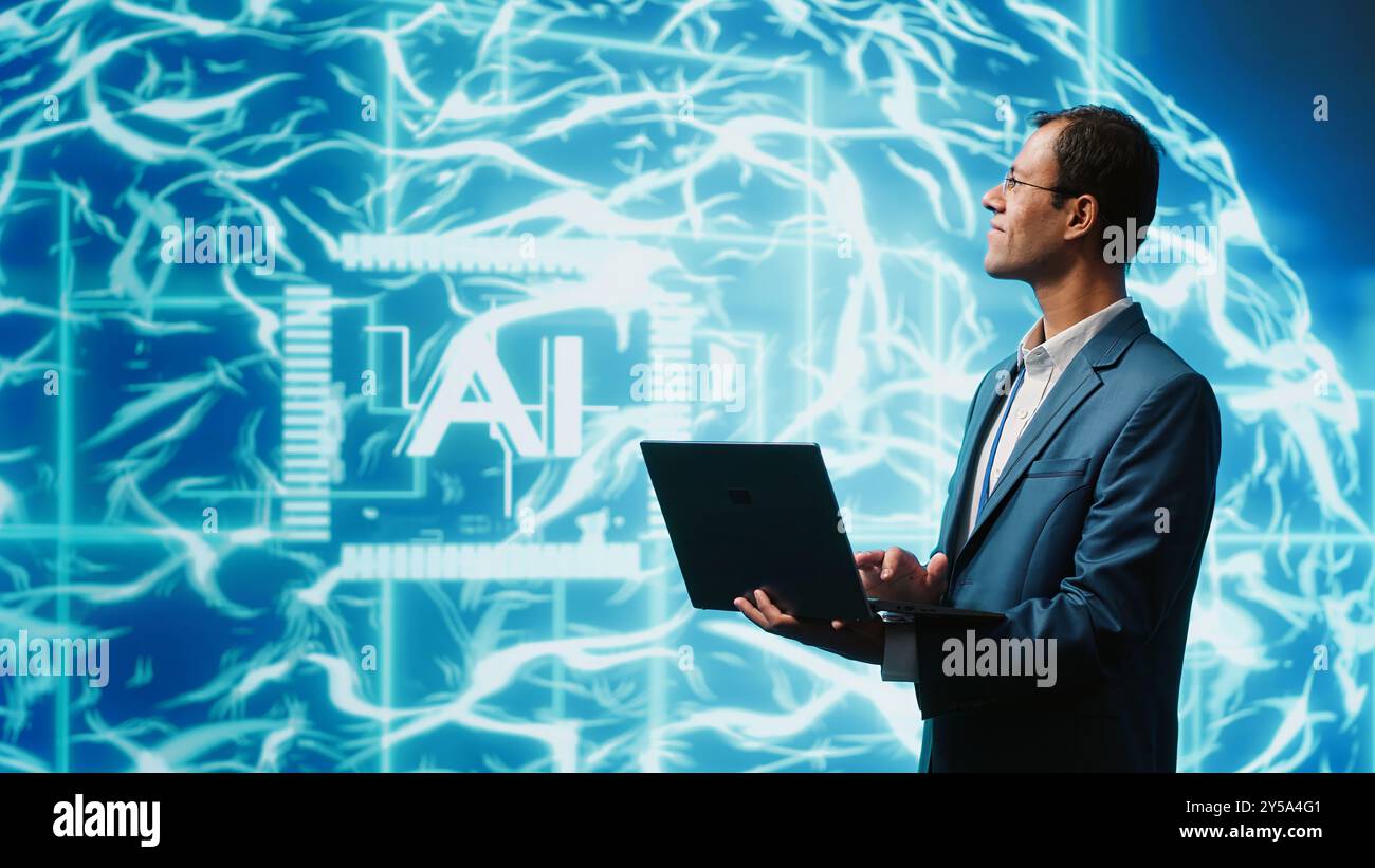 IT expert solving tasks on laptop device, running artificial intelligence programming scripts. Indian man using notebook to write lines of code for AI applications development, camera A Stock Photo