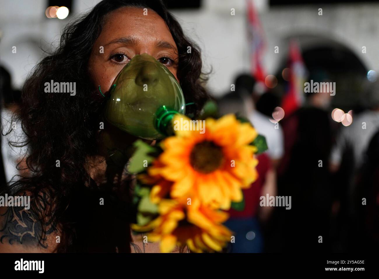 An environmental activist wearing an oxygen mask takes part in a global ...