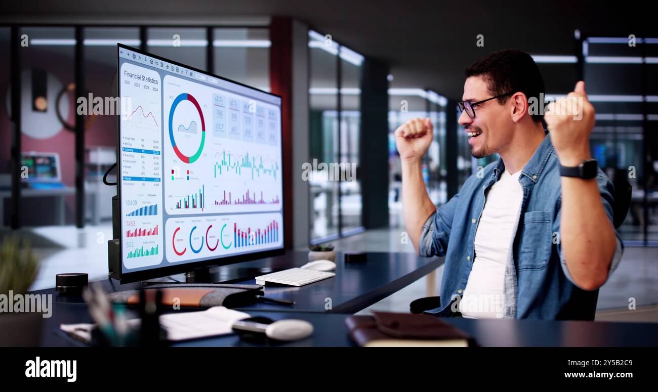Excited Business Analyst Using Data Dashboard On Computer And Celebrating Win Stock Photo