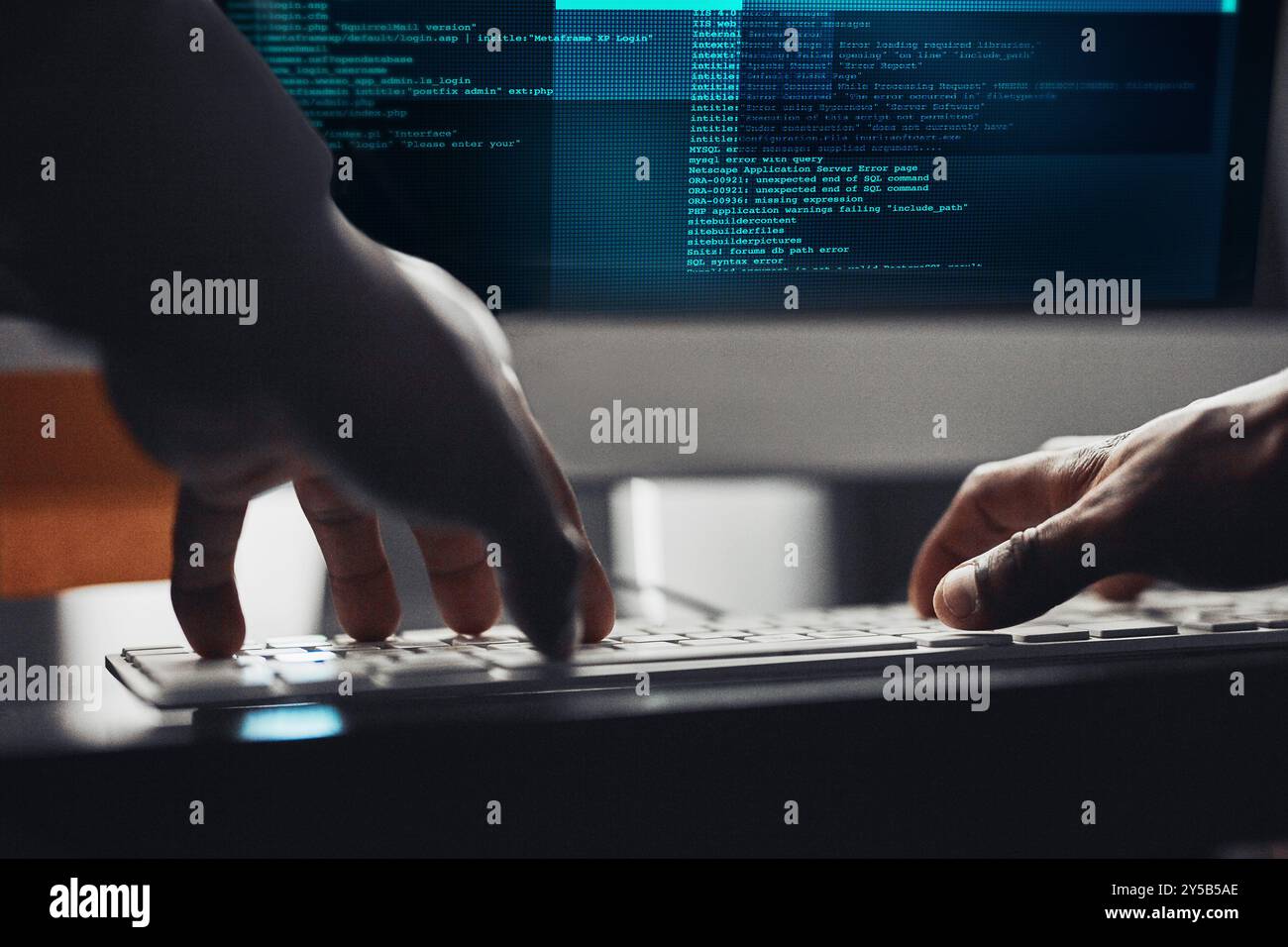 Hands, hacker and typing on computer for programming, data breach or cyber attack at night. Keyboard, closeup or person writing or coding malware Stock Photo
