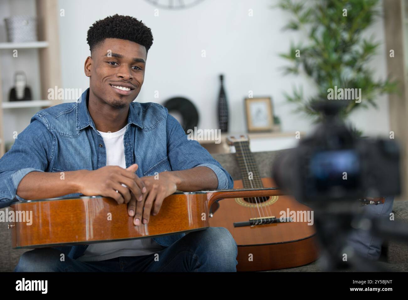 young guitar player recording video for his blog Stock Photo