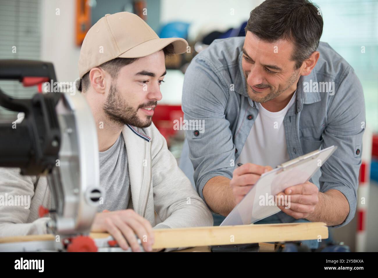 student and teacher in carpentry class Stock Photo