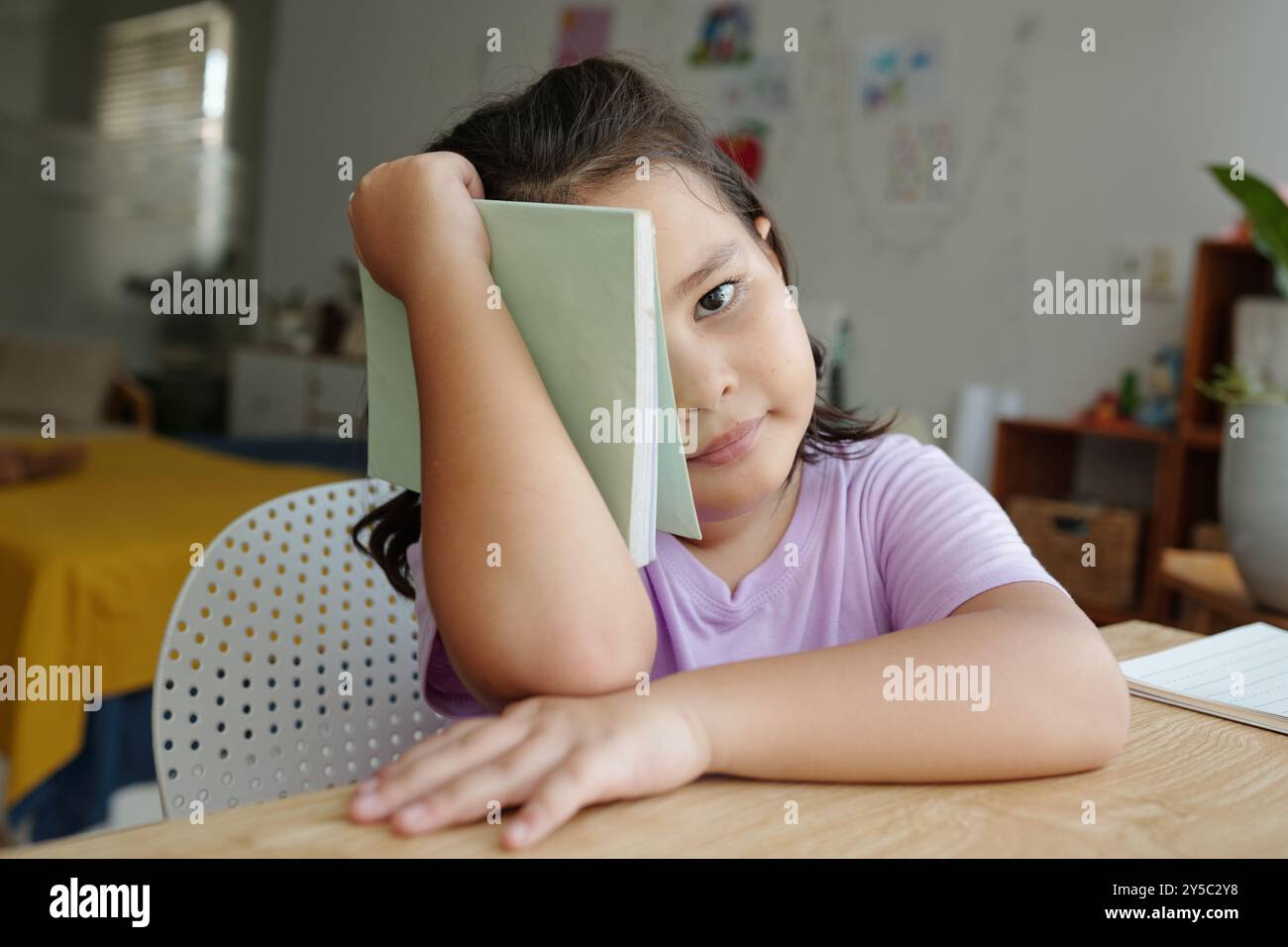 Little Girl Sitting At Her School Desk Stock Photo - Alamy