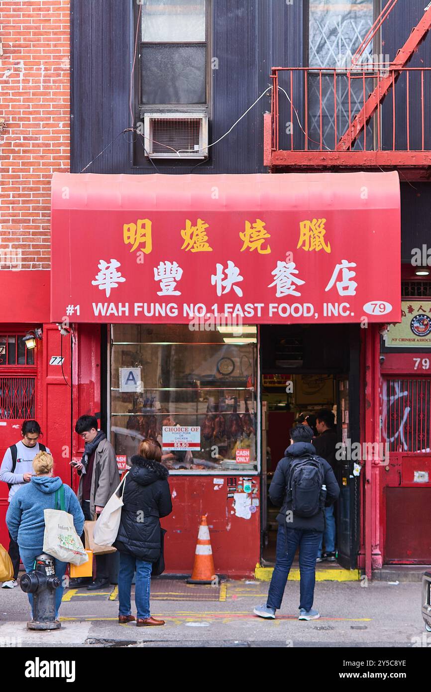 New York, United States -September 21,2024: Lively street scene in front of a well-known Chinese fast food restaurant in the heart of Chinatown. Stock Photo
