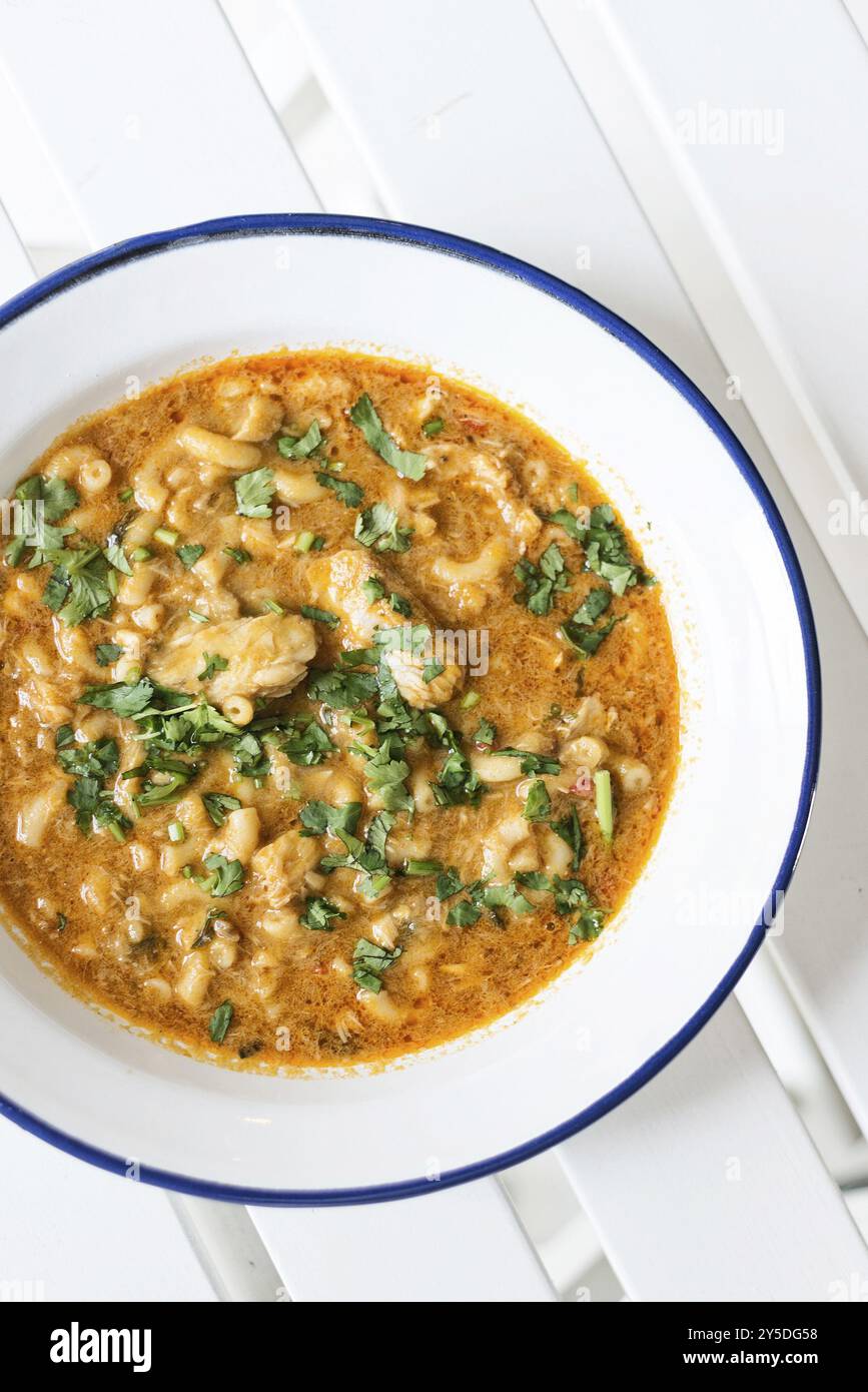 Creamy spicy seafood fish soup with coriander herbs Stock Photo