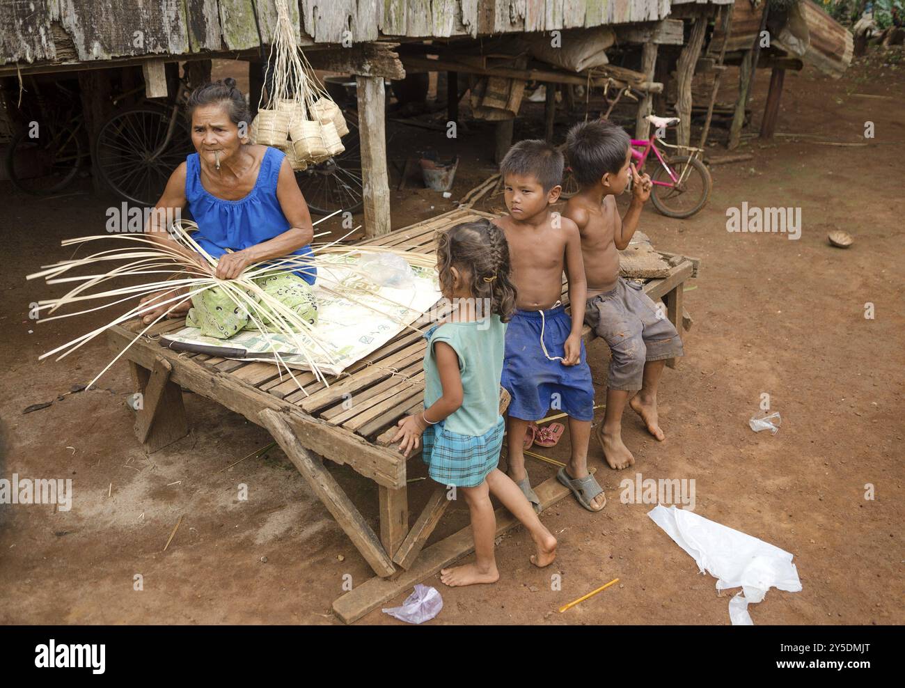 Elderly woman weaving basket in cambodia village Stock Photo