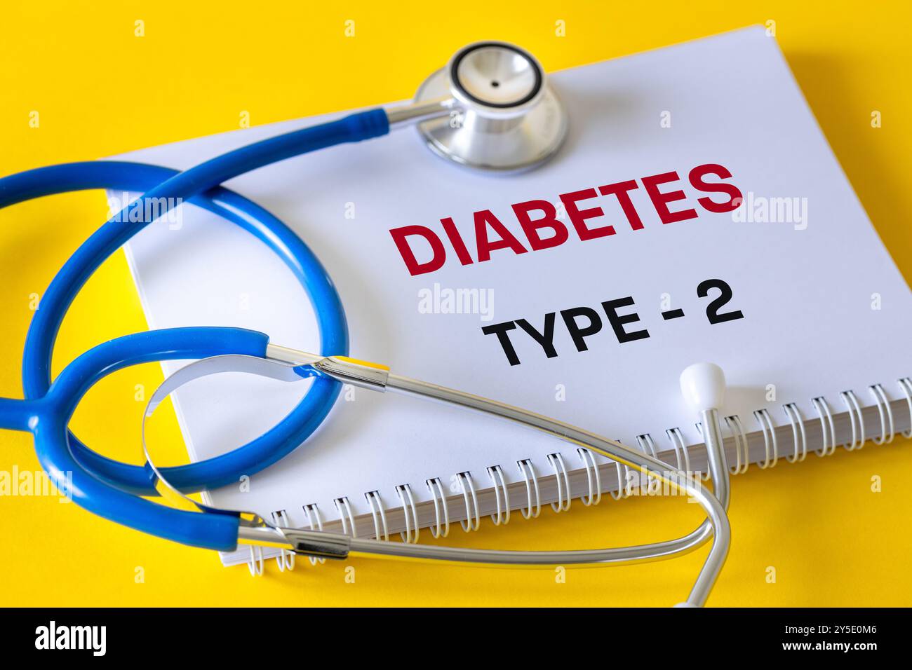 Diabetes type 2. health concept. Doctor's notebook with words diabetes type 2. Yellow background. Disease diagnosis, copy space Stock Photo