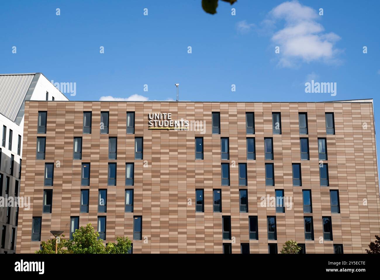 General view of a Unite Students halls of residence at Newcastle University with the Unite Students logo displayed as a sign on a sunny day. Stock Photo