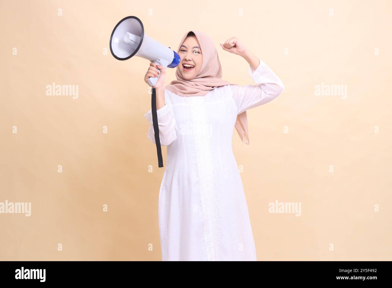 woman asian muslim wearing a hijab tilted right towards the camera ...