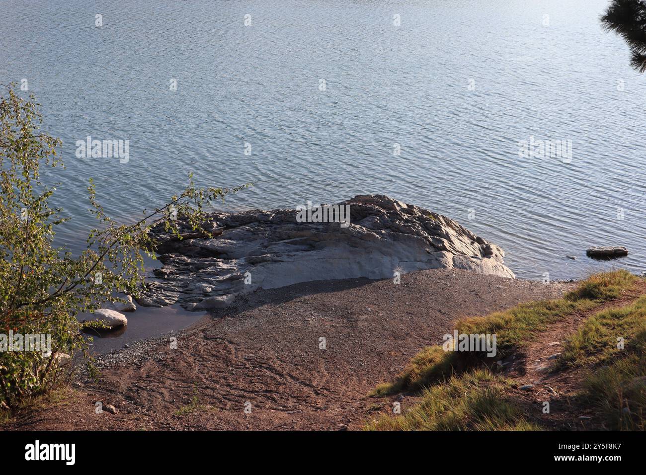 A scenic view of the shore of Foys Lake on a sunny day in the city of Kalispell's, Montana, United States Stock Photo