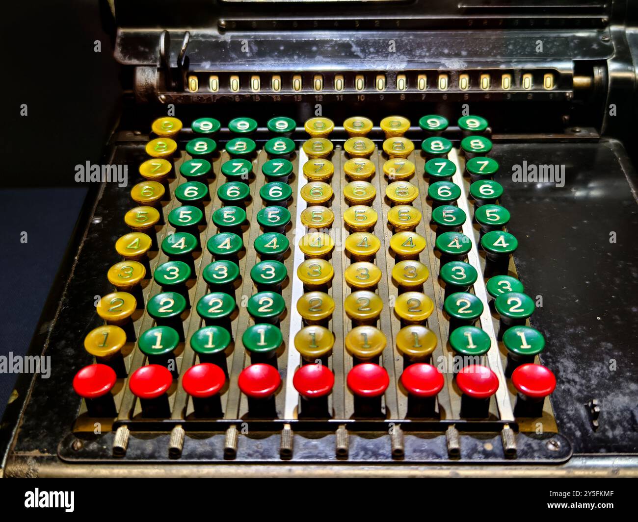 An old fashioned adding machine features a drawer located underneath it Stock Photo