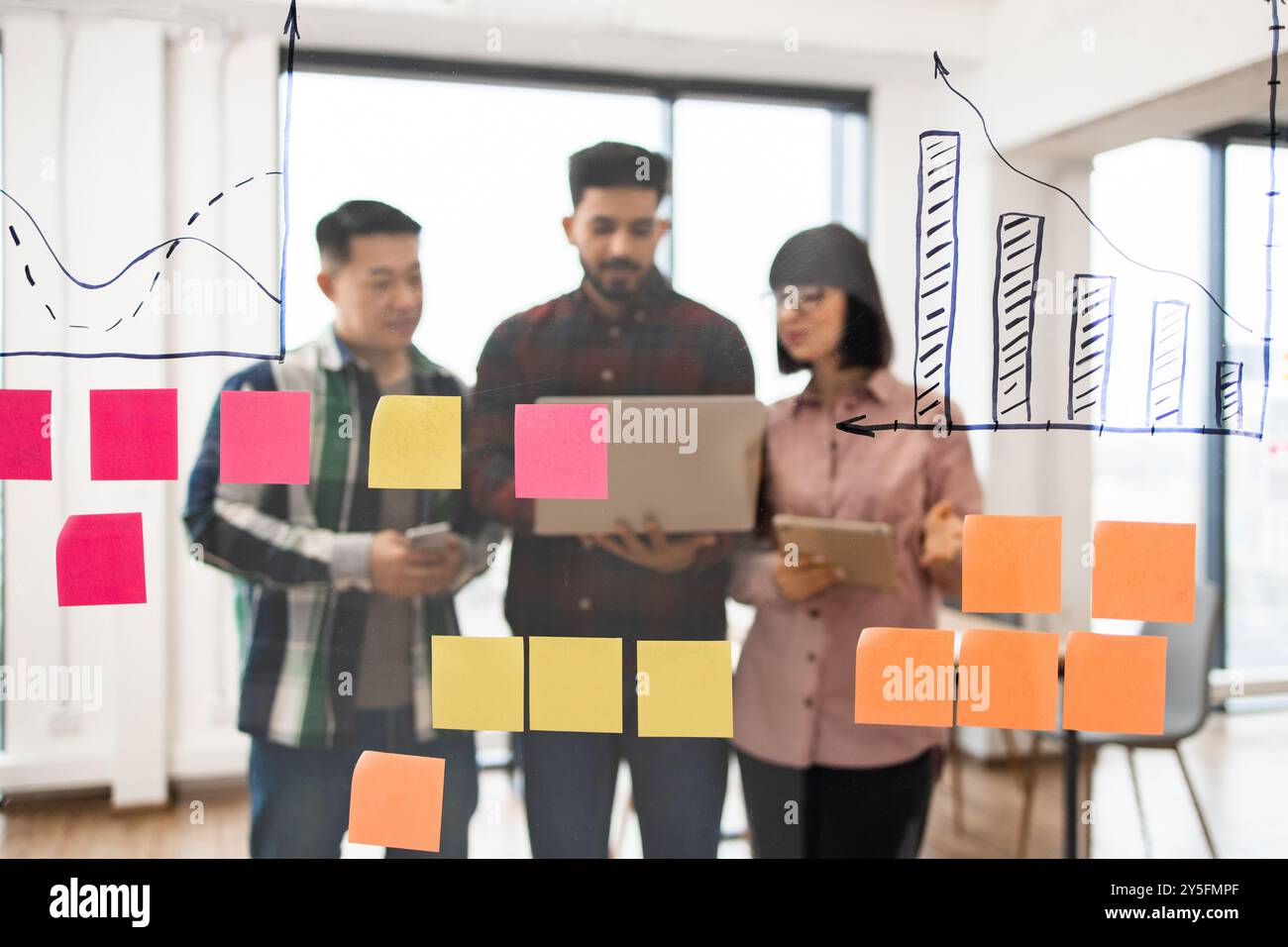Business team brainstorming with sticky notes and charts Stock Photo ...