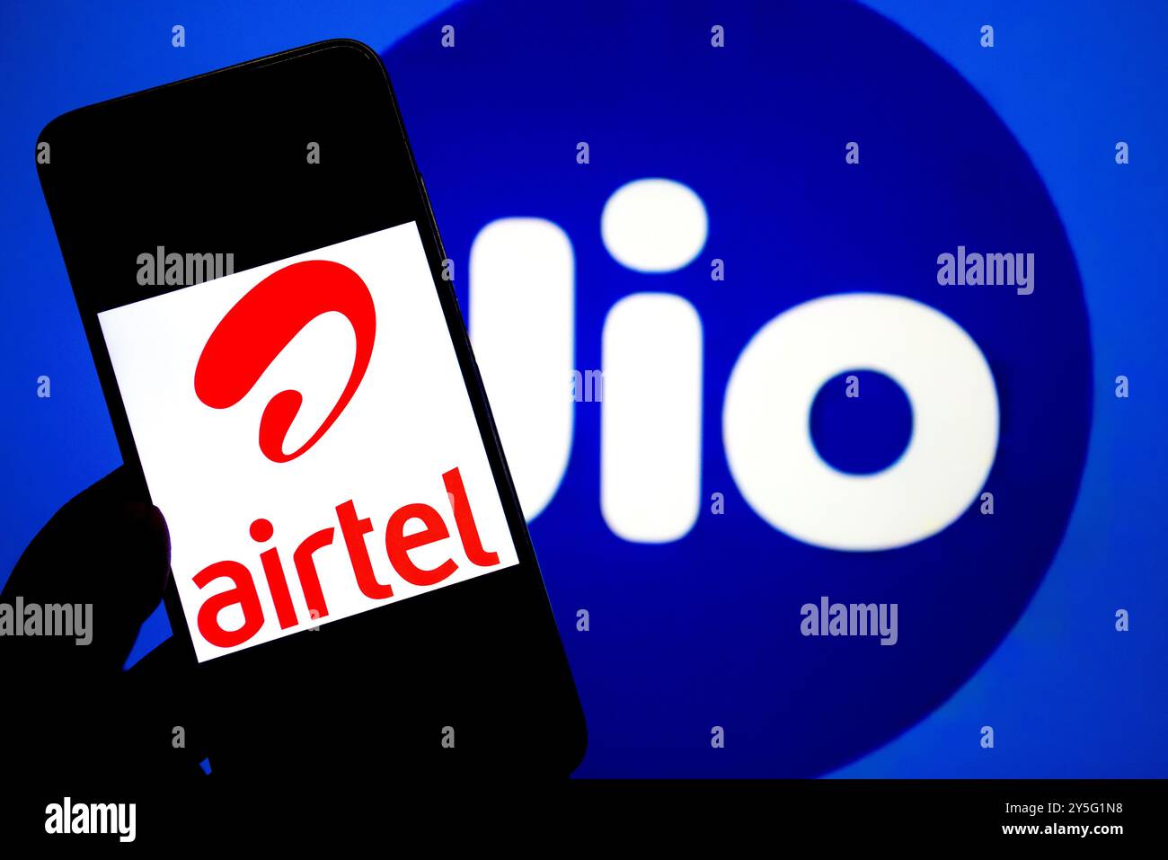 India. 21st Sep, 2024. In this photo illustration, an Airtel logo seen displayed on a smartphone with a Reliance Jio logo in the background. (Photo by Avishek Das/SOPA Images/Sipa USA) *** Strictly for editorial news purposes only *** Credit: Sipa USA/Alamy Live News Stock Photo