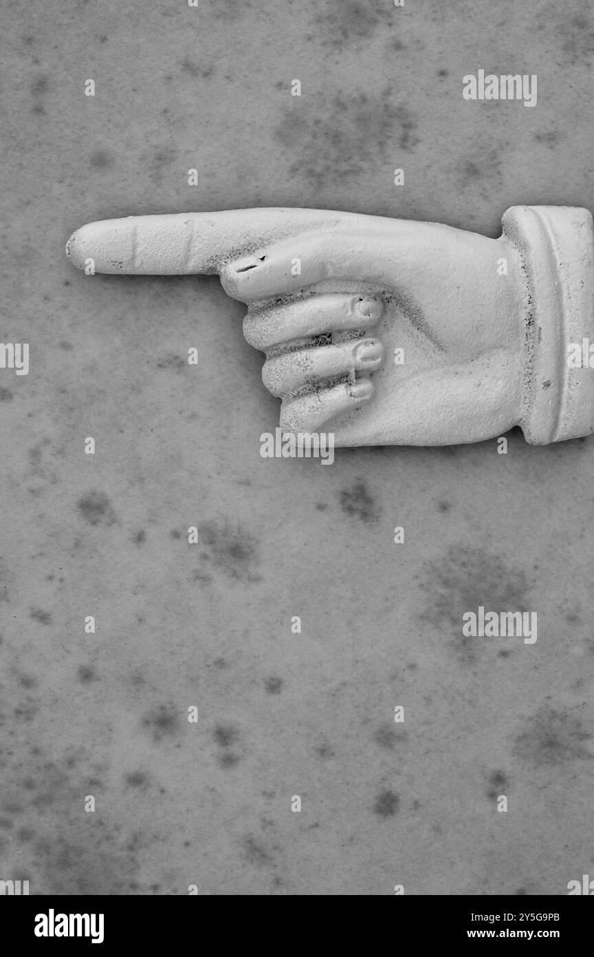 Monochrome image of painted metalVictorian hand with forefinger pointingsideways Stock Photo