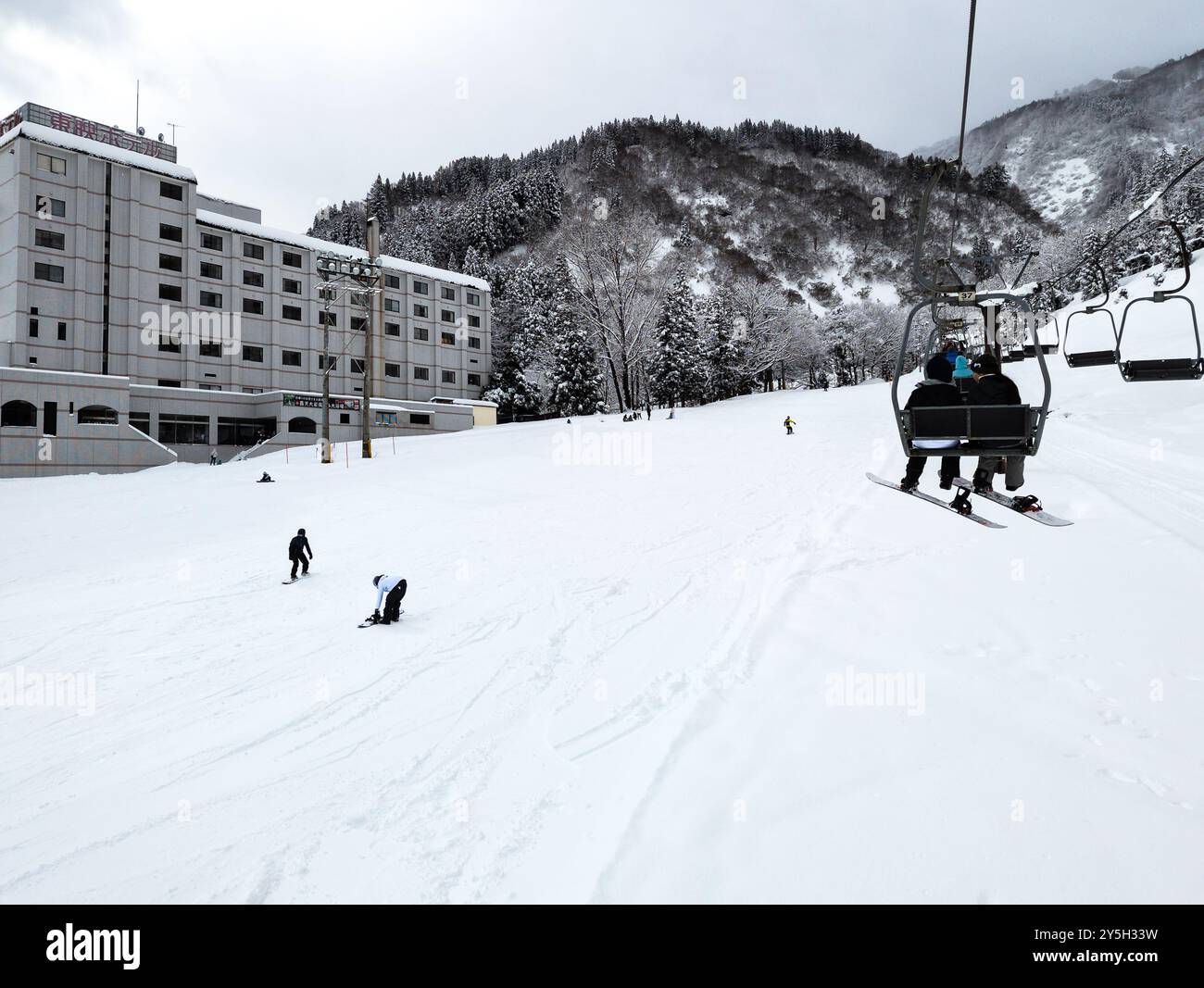 Snowboarders riding up ski lift hi-res stock photography and images - Alamy