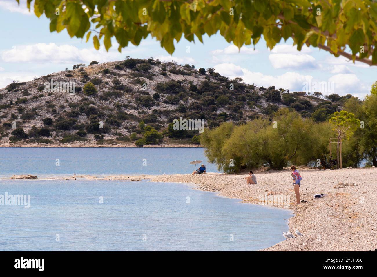 Vodice, Croatia - September 14, 2024: Beach with few people relaxing Stock Photo