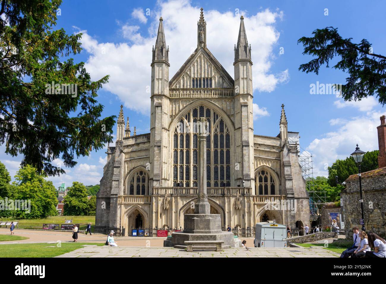 Winchester Cathedral and War Memorial Cross in Cathedral close in the City of Winchester Hampshire England UK GB Europe Stock Photo