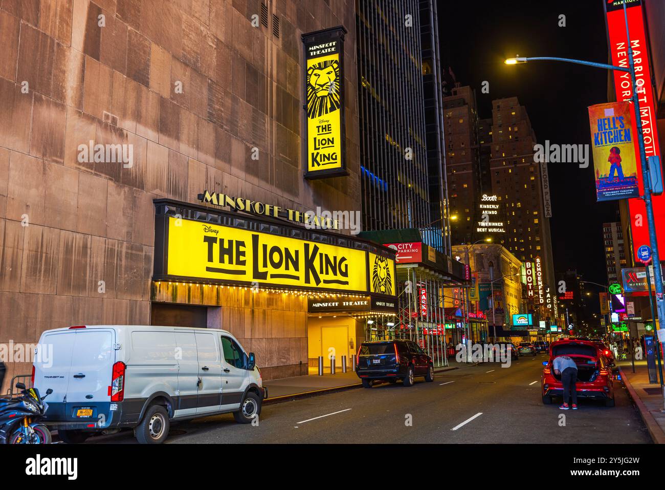 Exterior view of the Minskoff Theatre featuring 'The Lion King' musical signage on a quiet street in New York City at night. New York. USA. Stock Photo