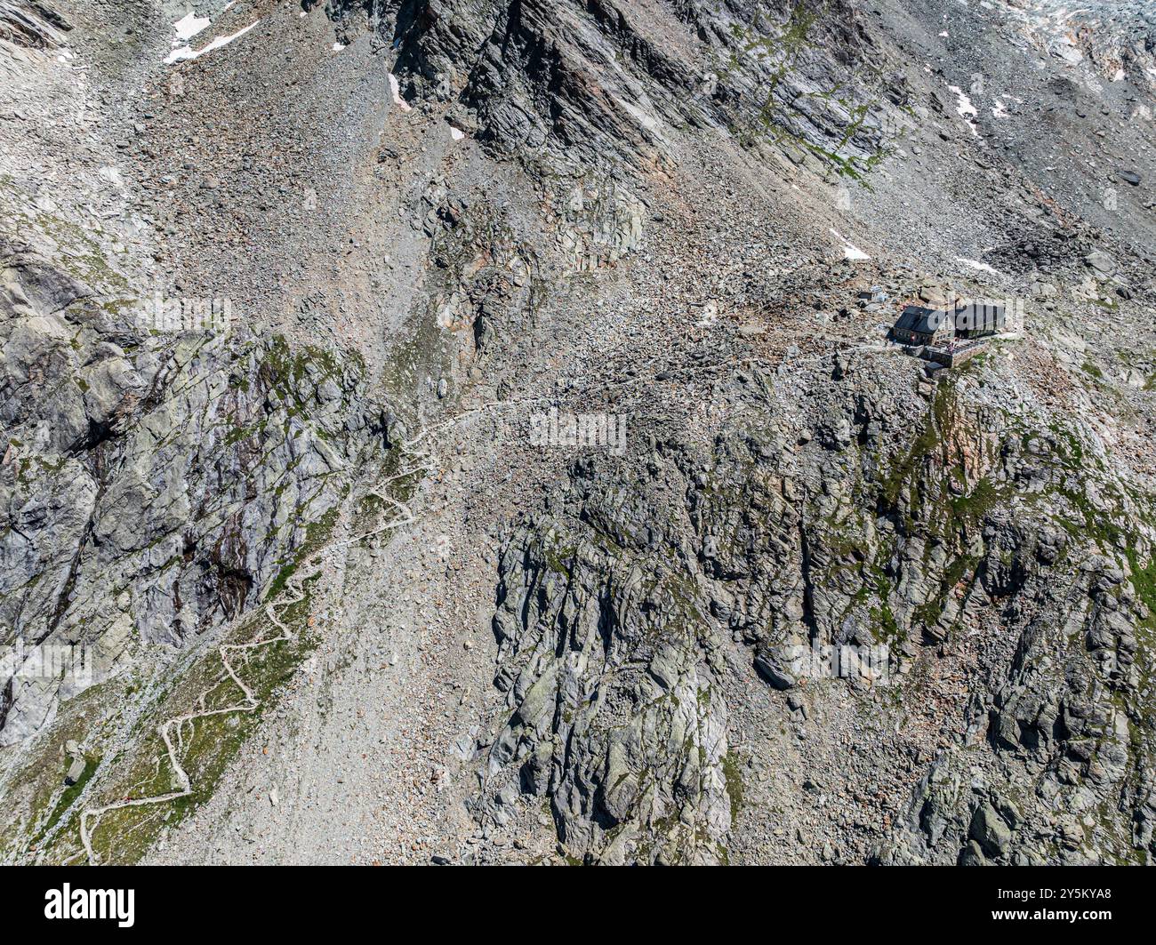 Mountain hut Cabane de Moiry, serpentines of hiking trail, aerial view, Valais, Switzerland. Stock Photo