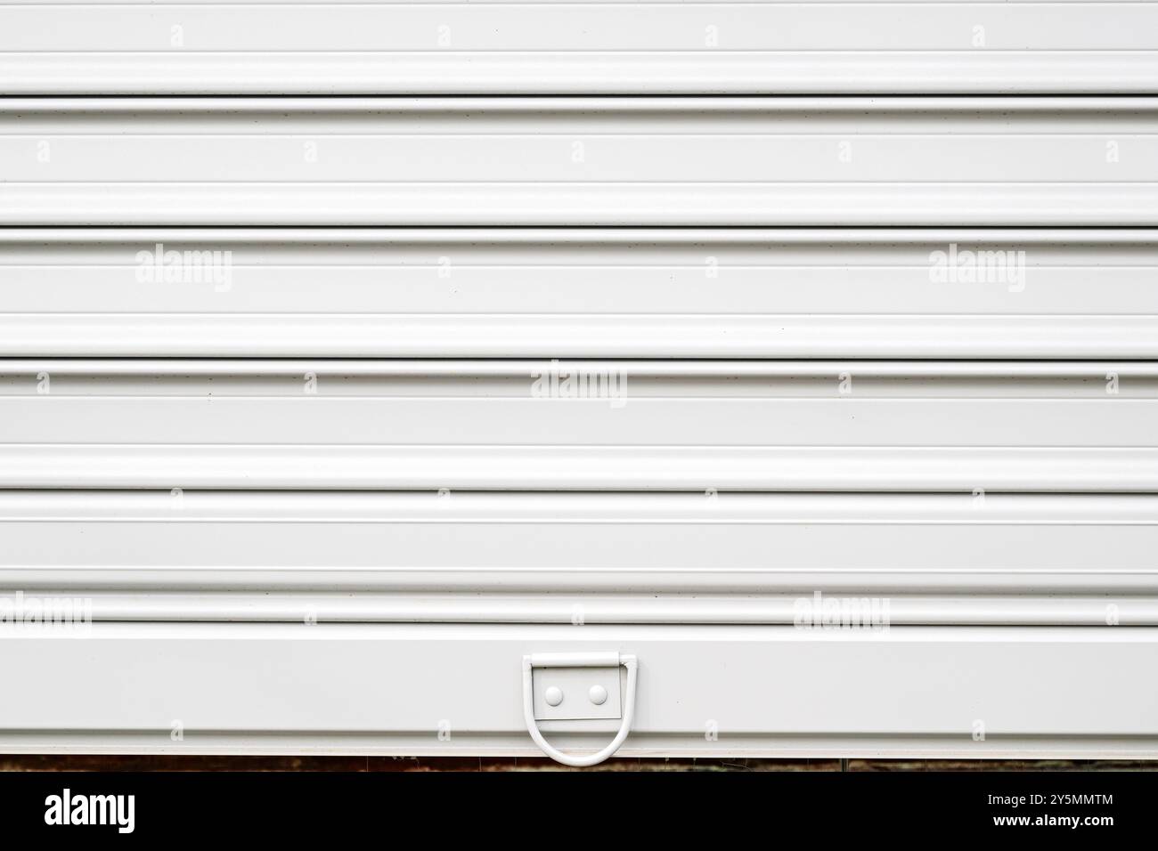White roller shutter metallic garage door as background and copy space Stock Photo