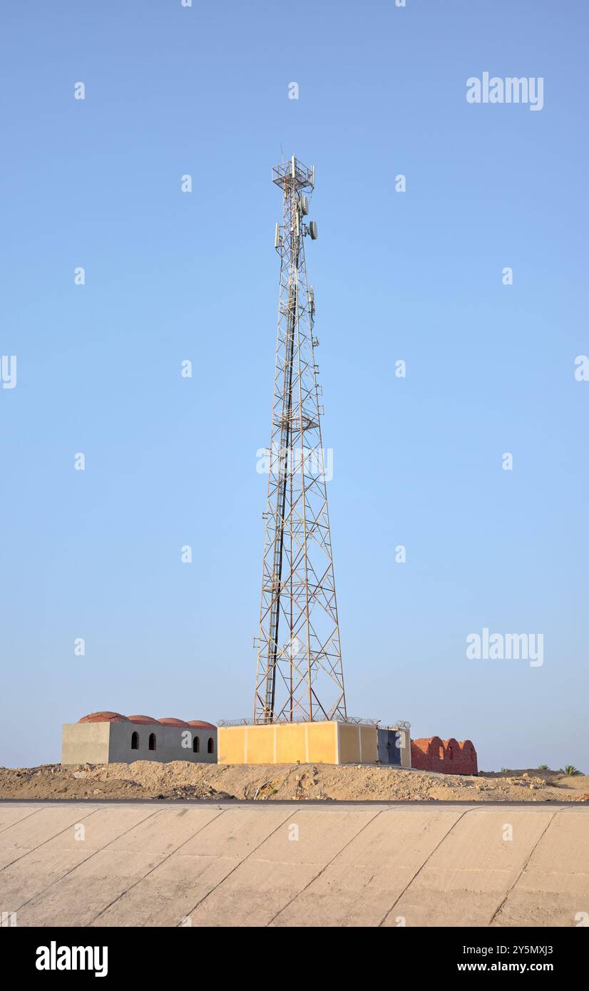 A photo of a telecommunications tower against a blue sky. Stock Photo