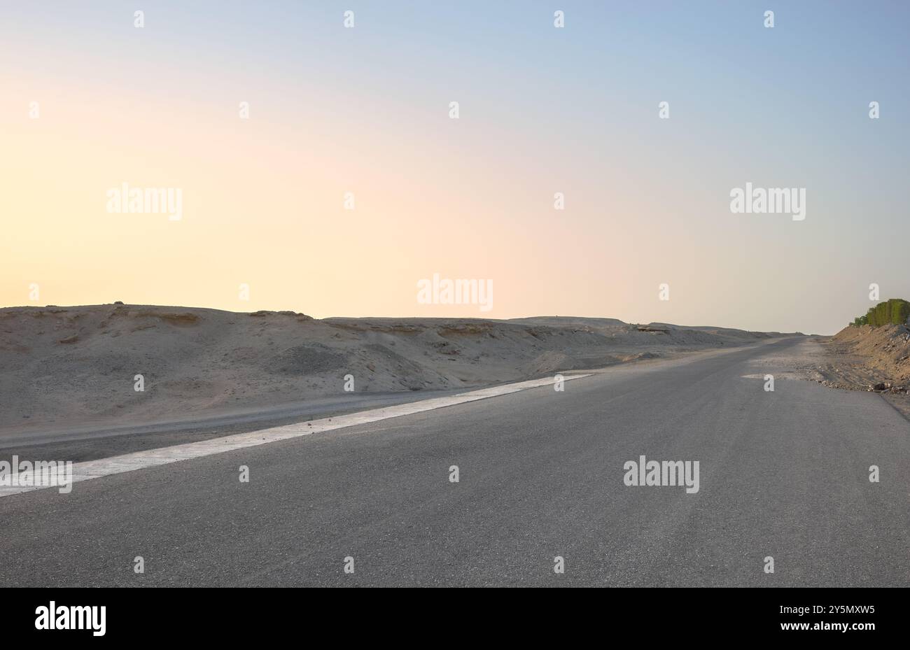 Empty desert road at sunset, front focus on asphalt, Egypt. Stock Photo