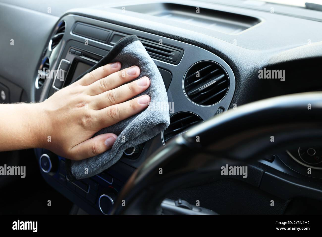 Man cleaning center console with rag, closeup Stock Photo - Alamy
