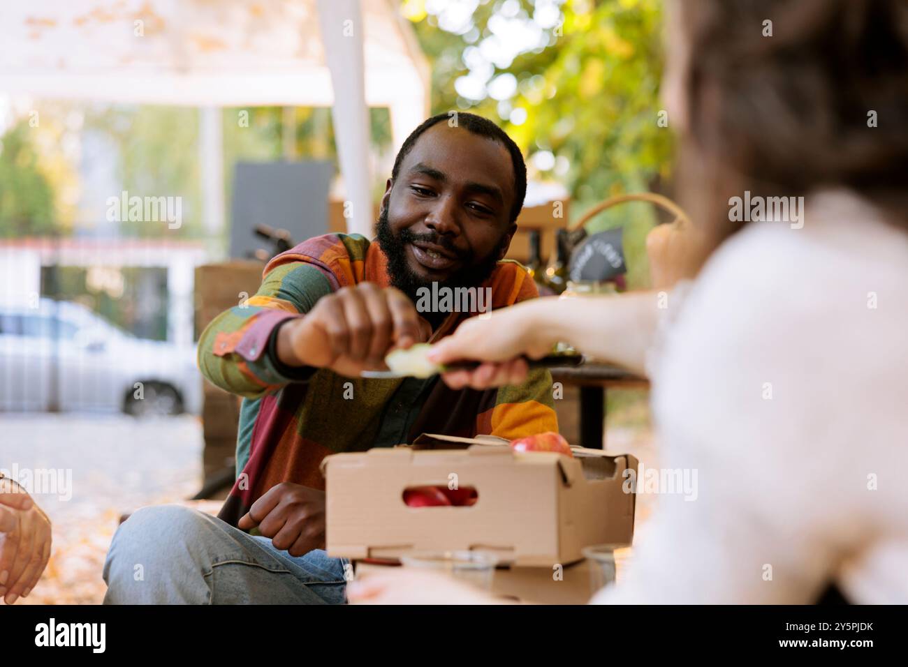 African american client sitting and sampling freshly harvested organic ...