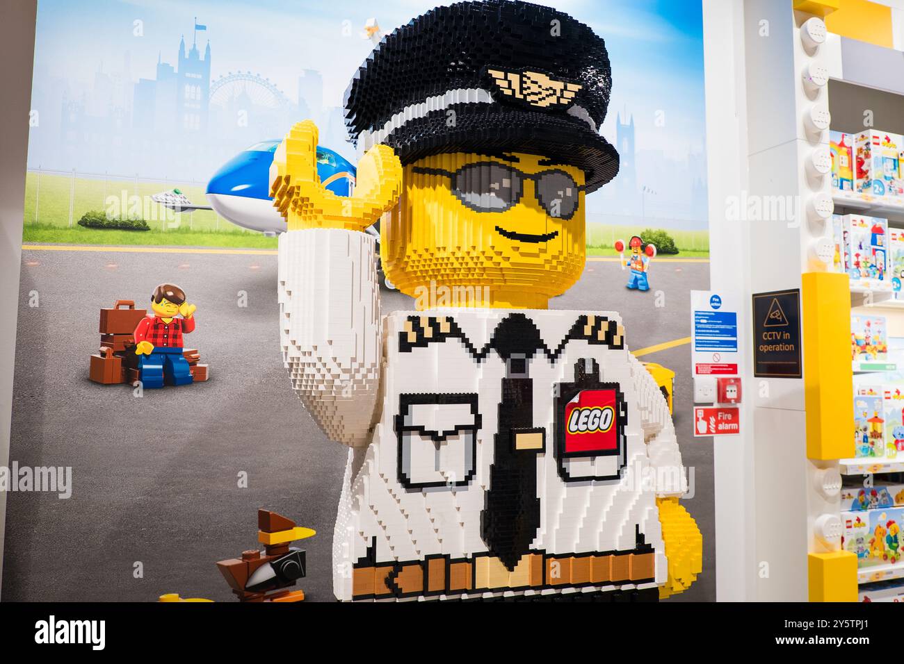 London, UK - July 26, 2024: Huge Lego sculpture of a smiling police man at the Lego shop in Luton Airport. Stock Photo