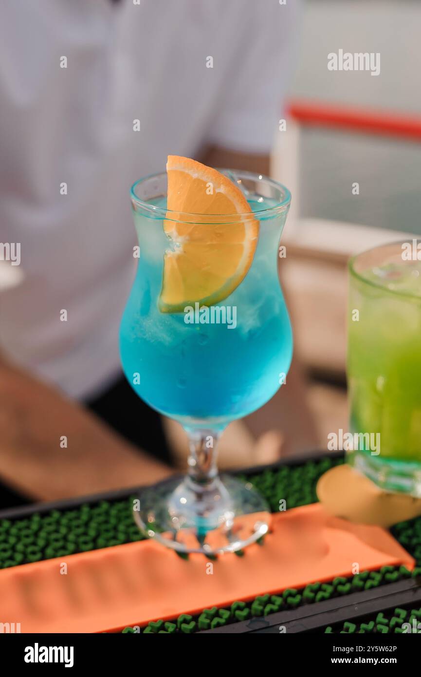 Refreshing Tropical Blue Cocktail with Citrus Garnish on Vibrant Bar ...