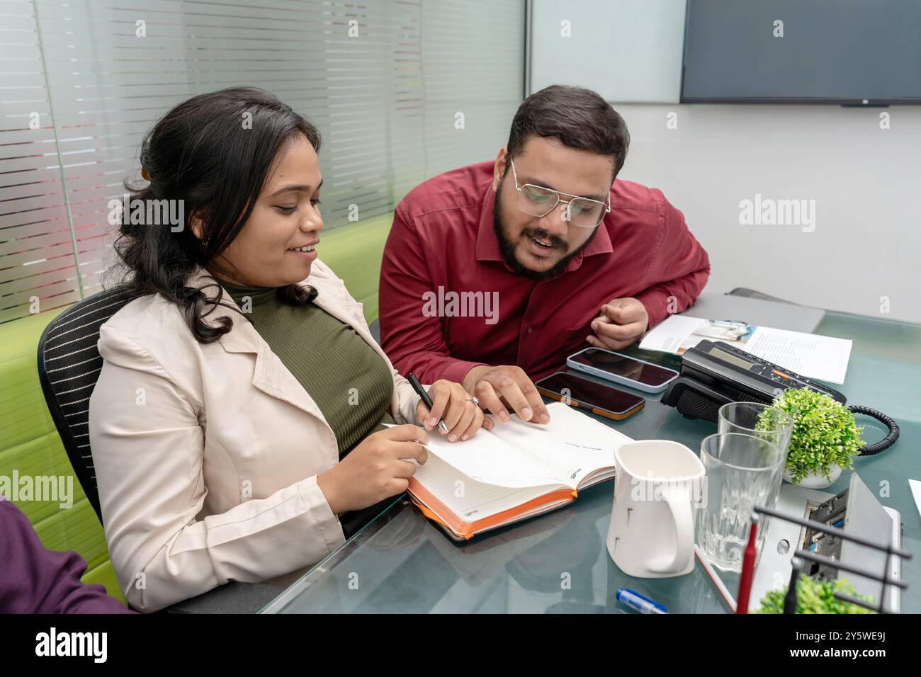 A happy Indian couple, husband and wife, engaged in financial planning ...