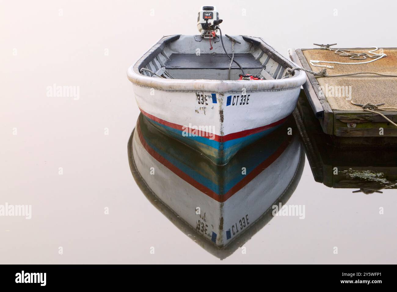 Motor boat tied to a dock Stock Photo - Alamy