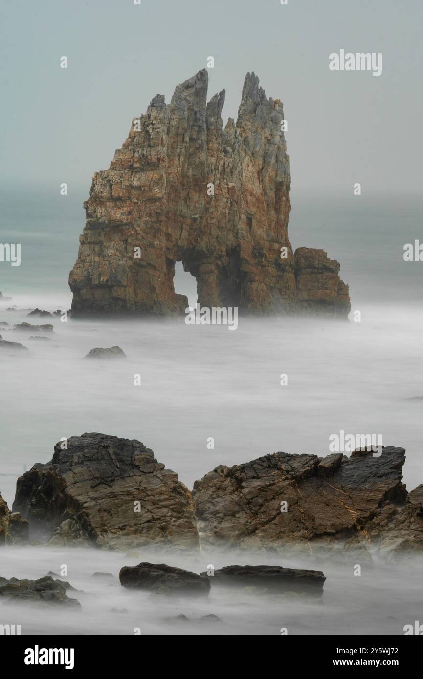 Solitary Sea Stack Emerging from the Misty Ocean Stock Photo - Alamy
