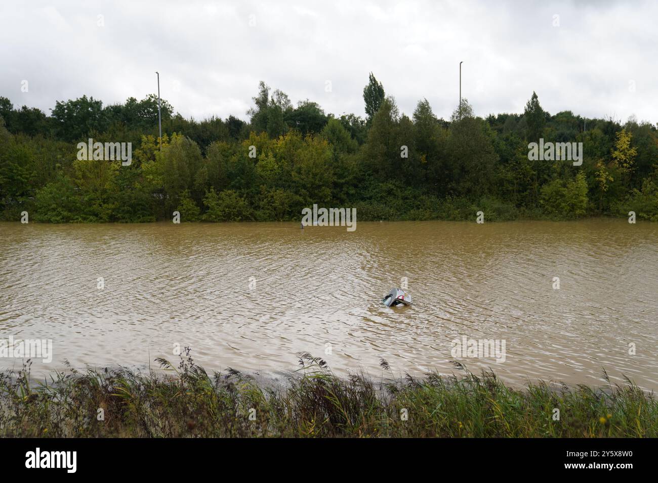 the-open-boot-of-a-car-is-visible-above-the-water-where-the-vehicle-is