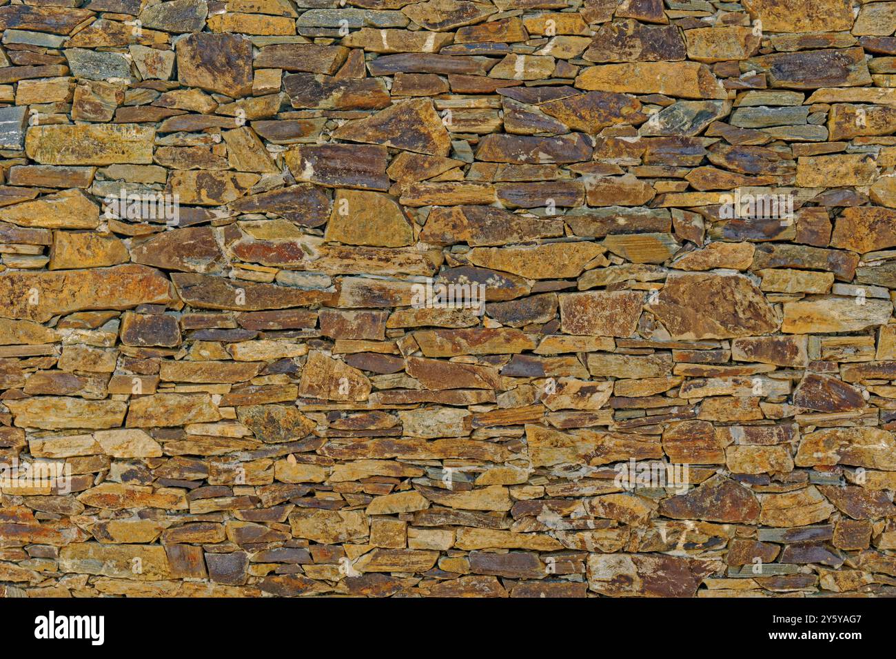 Rustic stone wall facia. Stock Photo