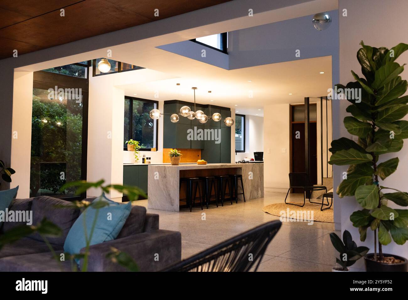Modern kitchen with marble island and bar stools in stylish open-plan ...