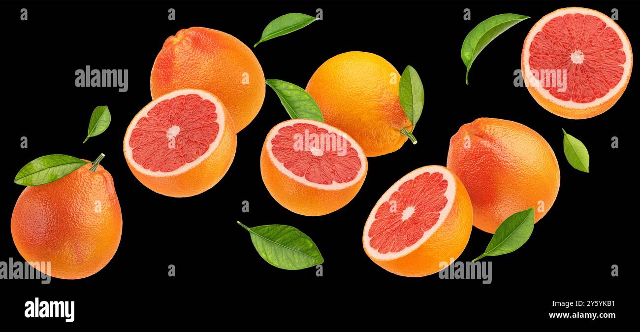 Falling grapefruits isolated on black background Stock Photo
