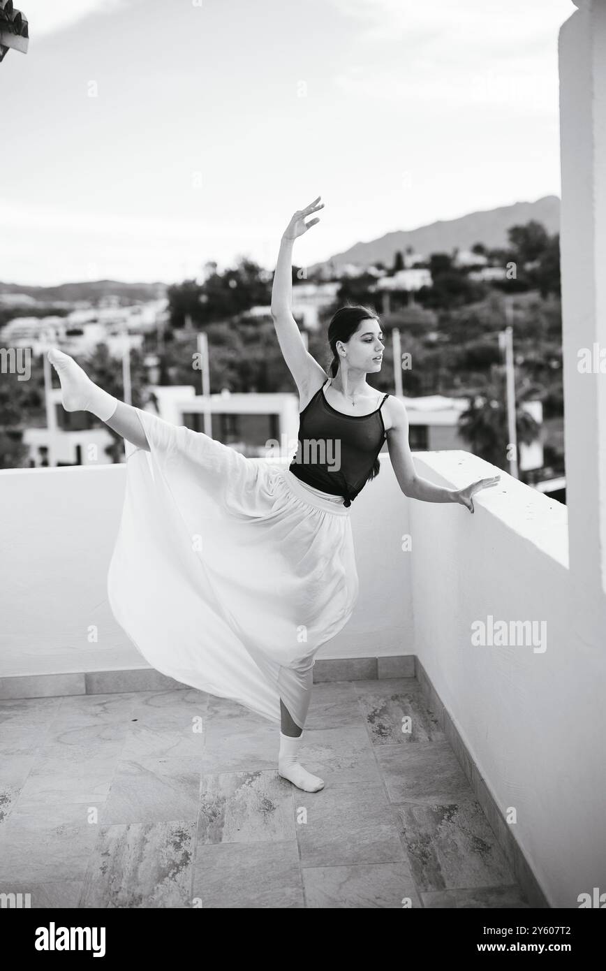 An Elegant Ballerina Posing Gracefully on a Balcony in a Beautiful ...