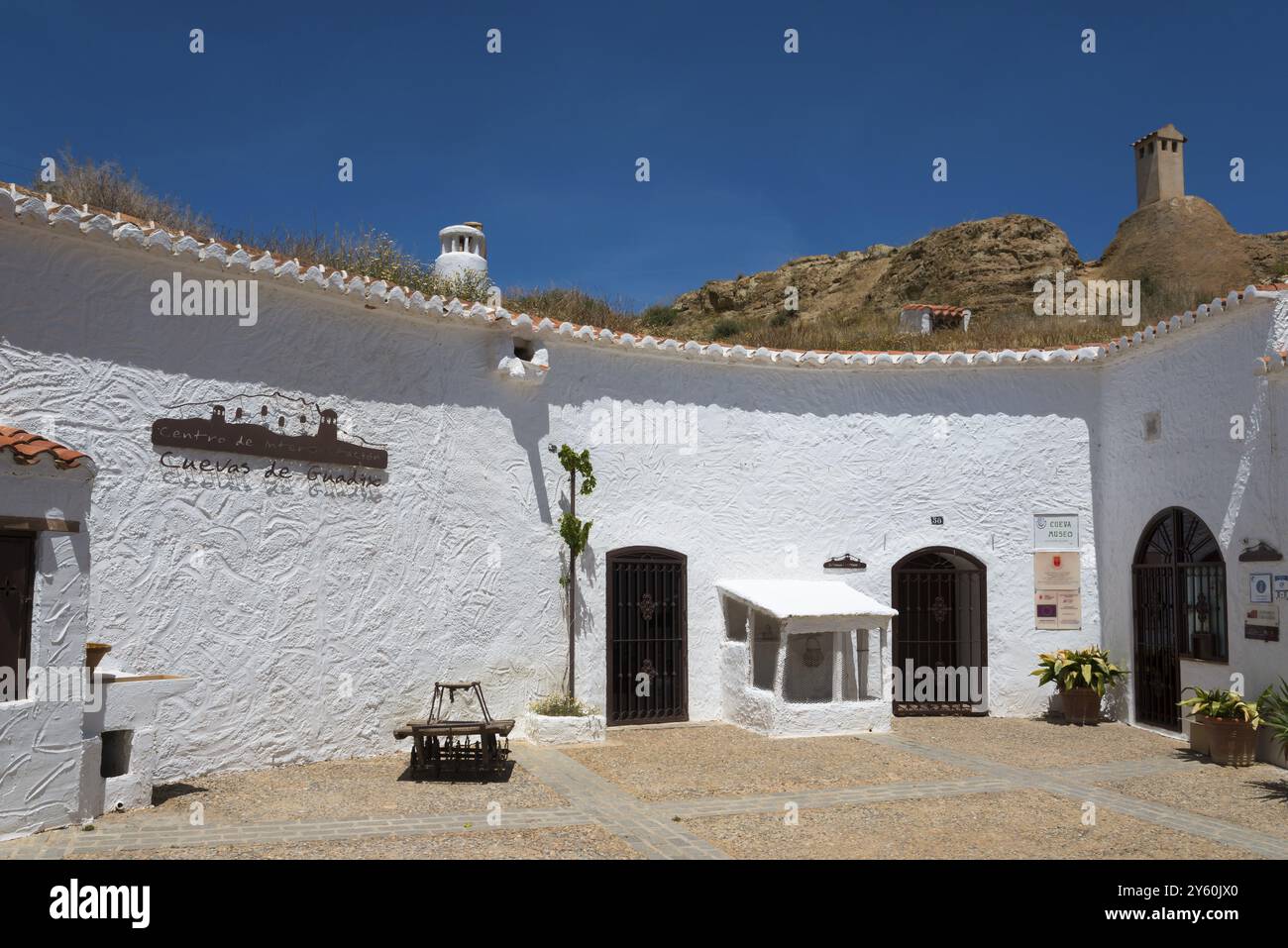Rustic Museum Div White courtyard with historic buildings and rustic ambience under a ...