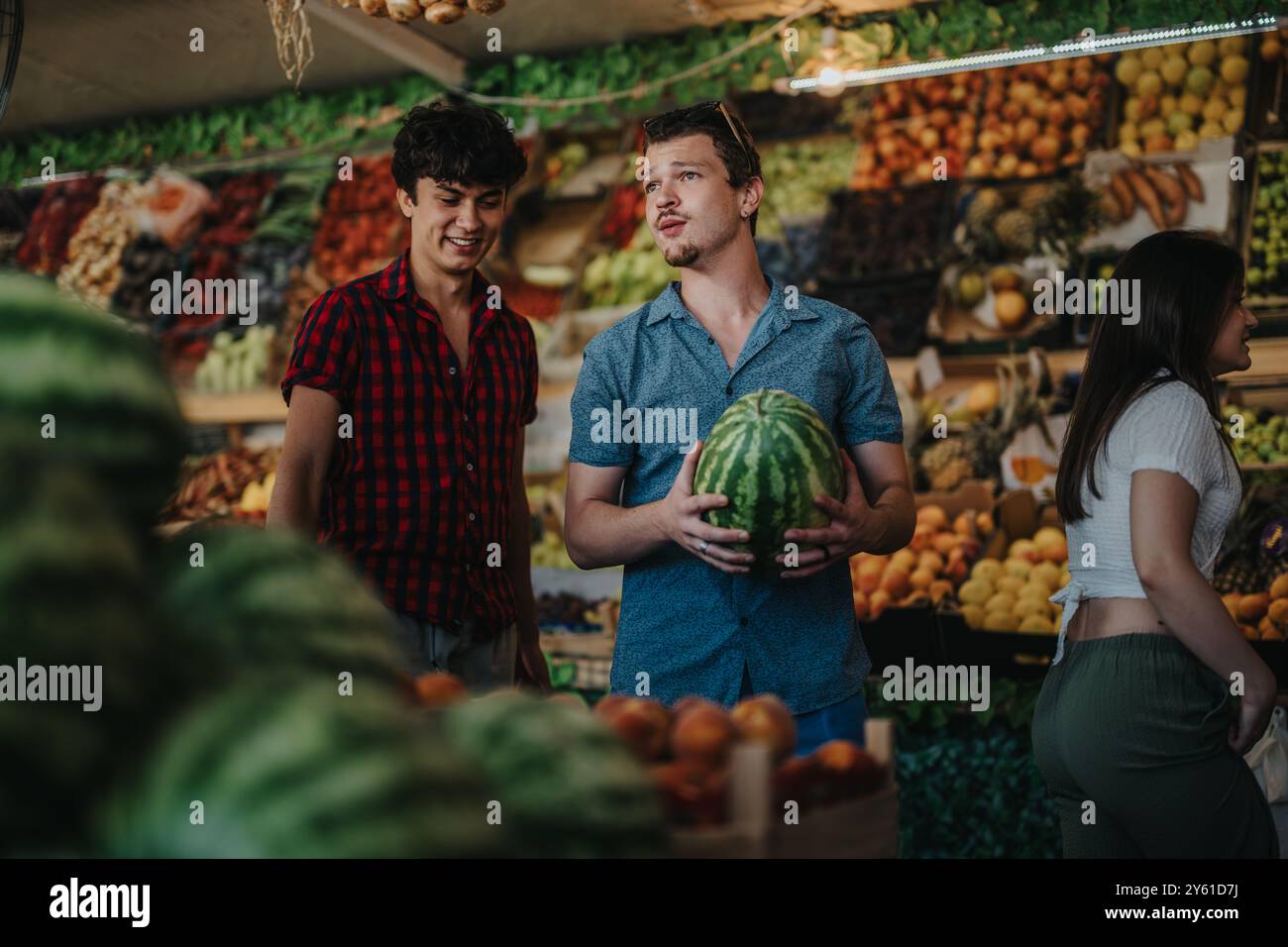 Friends enjoying buying fresh fruits at a bustling market Stock Photo ...