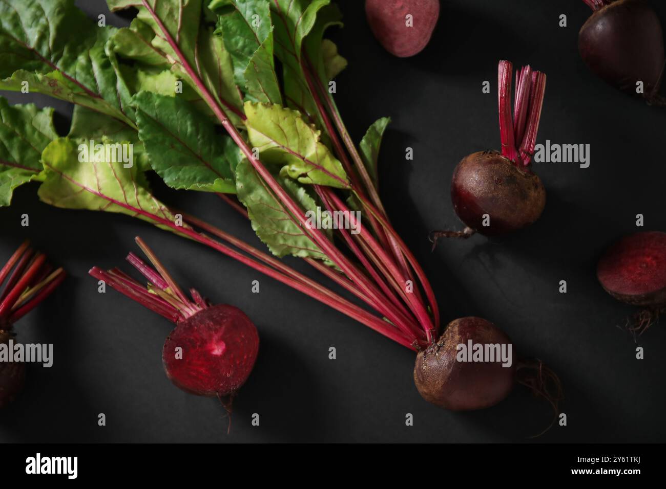 Fresh beets with green leaves on black background Stock Photo