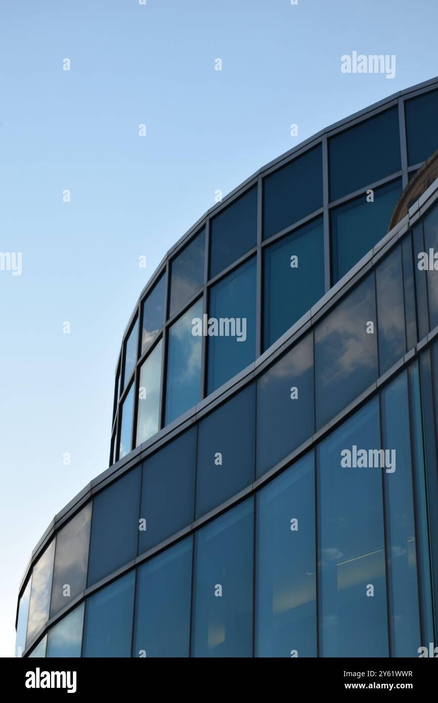 Blue sky reflected on glass building Stock Photo - Alamy