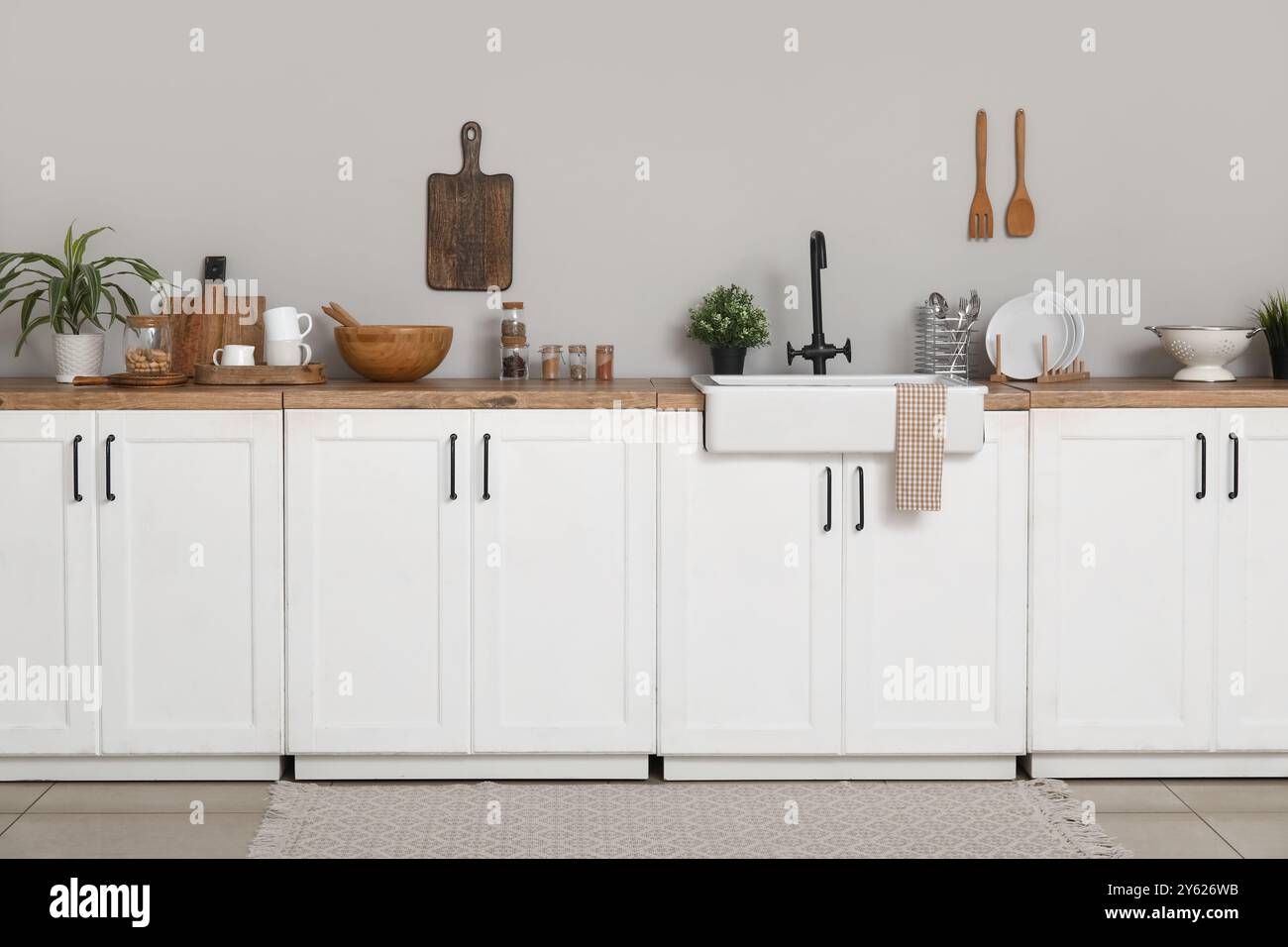 Interior of light kitchen with white counters, sink and utensils Stock ...