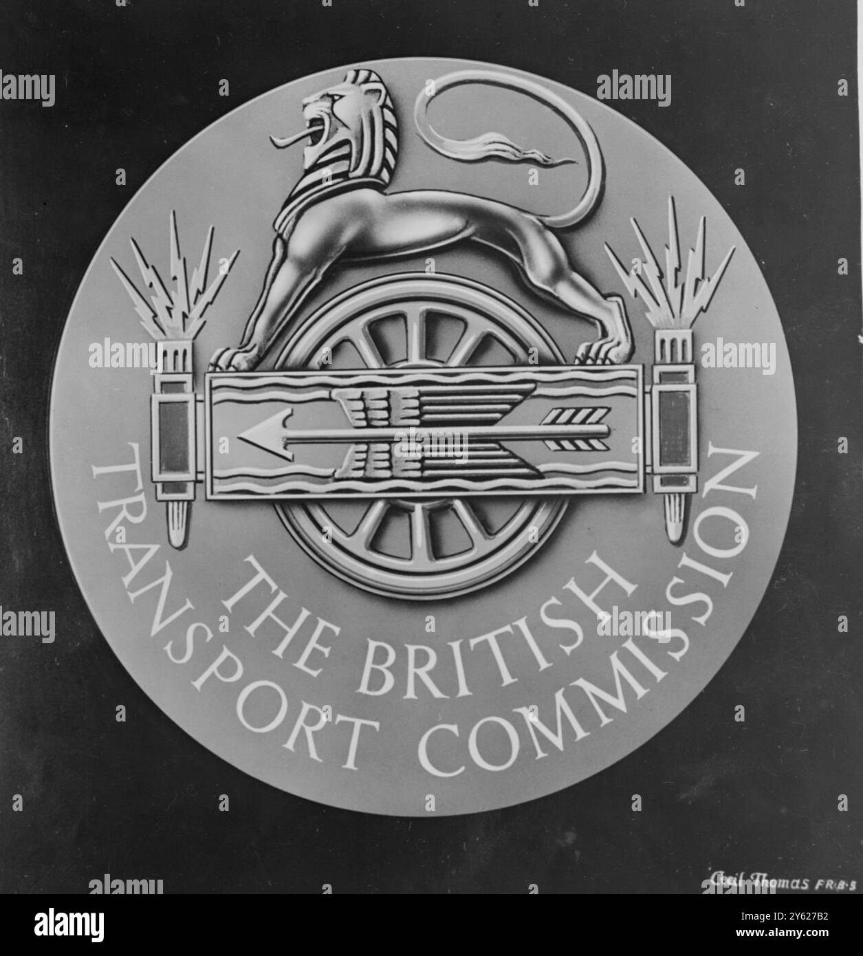 The Seal of the British Transport Commission is being engraved by Mr. Cecil Thomas F.R.B.S., the well-known sculptor, whose design has been accepted by the Commission. The design consists of a lion, representing Great Britain, bestride a composite symbol which includes a wheel, a winged arrow superimposed on the pattern of wavy lines (symbolising the activities of the Docks and Inland Waterways Executive) and a pair of torches emitting flashes of lightning (symbolising modern forms of warfare). The seal which will be 2 inches in diameter, is being modelled in clay and will be finished by engra Stock Photo