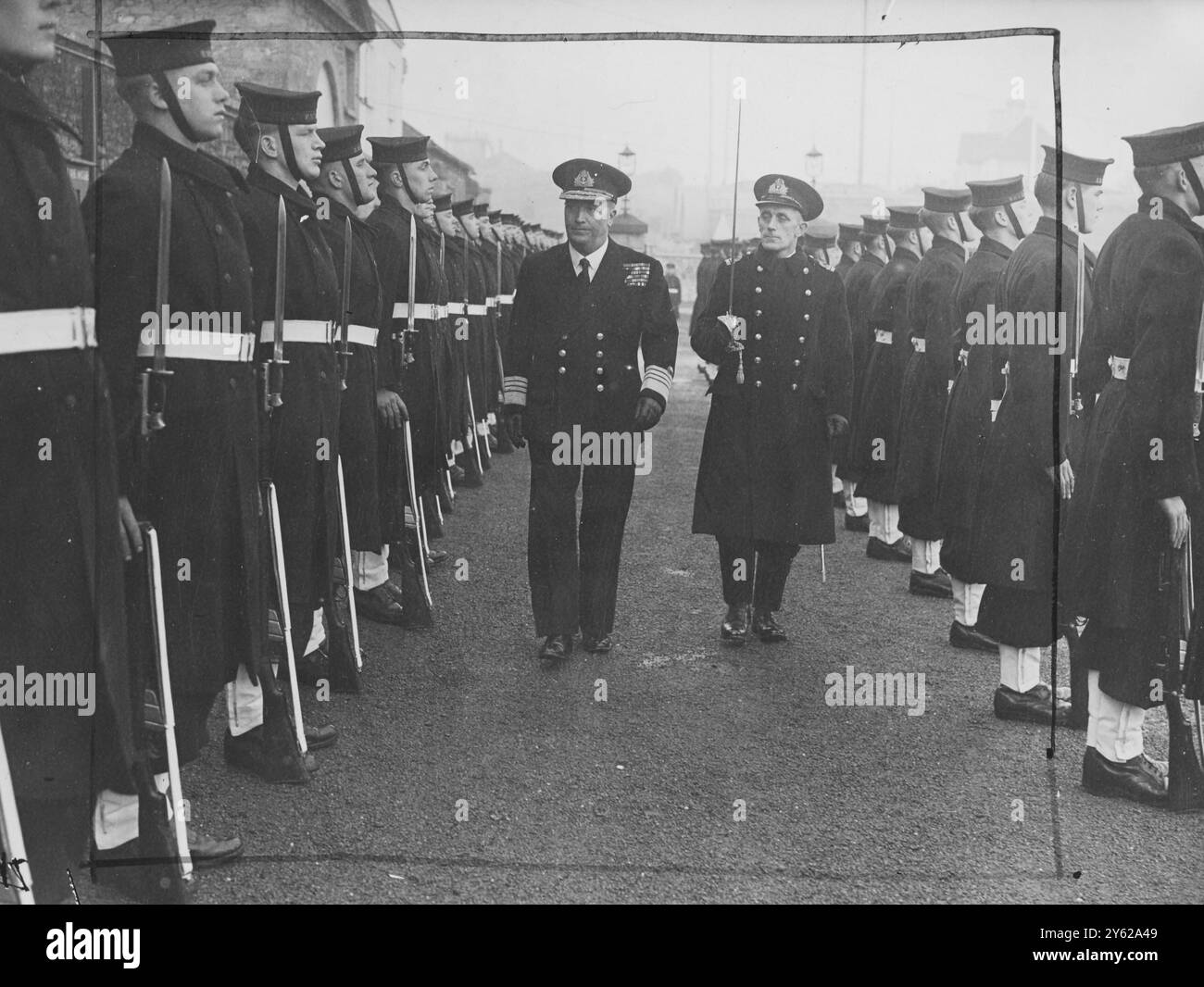 A salute of 17 guns marked the taking over of Plymouth Command by Adml Sir Robert L. Burnett, KBE, CB, DSO, Ll.B., who succeeds Adml Sir Henry D. Pridham-Wippell KCB, CB, C.V.O. Massed Royal Marine bands from HMS Drake, Raleigh and Imperieuse beat retreat when Sir Henry's flag was hauled down at sunset at Mount Royal. Picture shows: Sir Robert Burnett inspects a guard of honour on arrival at Admiralty House to take over the post of   C. in C., Plymouth.  2 December 1947 Stock Photo