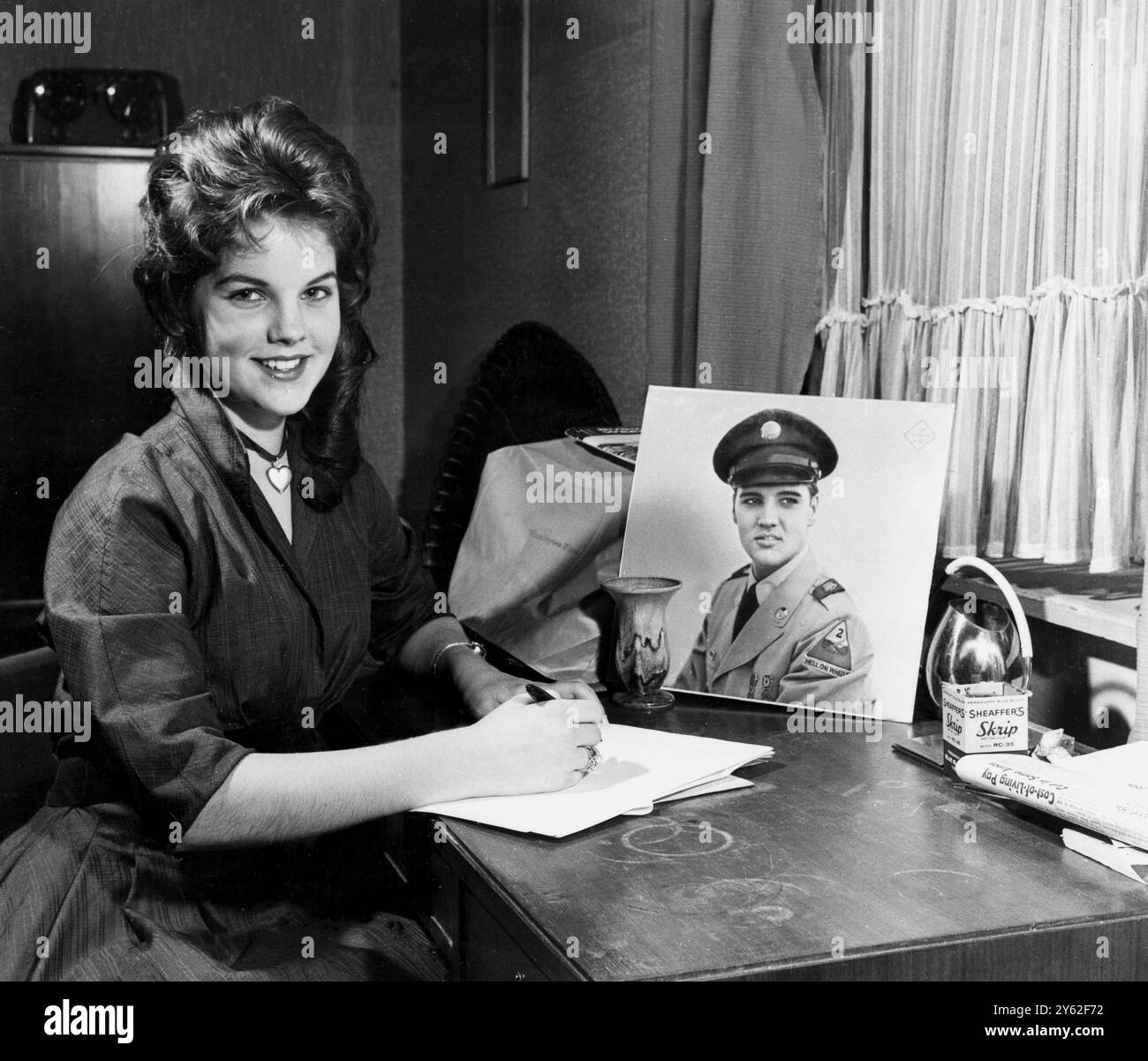 2nd March 1960: Wiesbaden, West Germany. 16 yr old Priscilla Beaulieu, daughter of a United States air force captain from Austin, Texas, writes a letter to her friend, Elvis Presley. She has been the steady date of the star for six weeks. Elvis is set for discharge from the army and will fly home back to his lucrative singing career. UPI Stock Photo